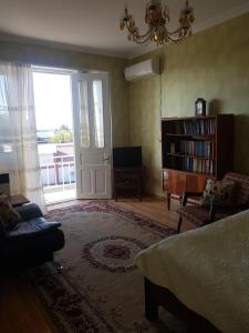 a living room with a couch and a window and a door at Recalls in Samtredia