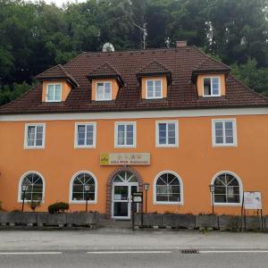 an orange building with a brown roof at Asia wok gasthof in Ybbs an der Donau