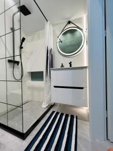 a bathroom with a sink and a mirror at Apartament VIP Sztutolo z basenem in Sztutowo