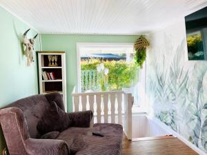 a living room with a couch and a window at Ferienhaus Peppi - Haus am See in Güster