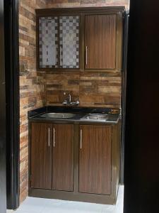 a bathroom with a sink and wooden cabinets at فندق بلفيو بارك رويال Bellevue Park Royal Hotel in Taif