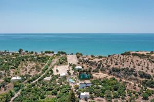 an aerial view of a house on a hill next to the ocean at Villa Vigla Keratokampos in Keratokampos