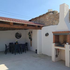 a patio with a table and chairs next to a building at Casa Huidobro Valle 