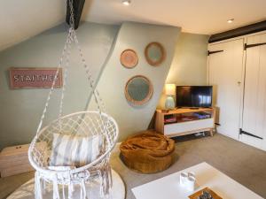 a living room with a swing and a tv at Corner House in Saltburn-by-the-Sea