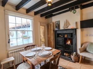 a dining room with a table and a fireplace at Corner House in Saltburn-by-the-Sea