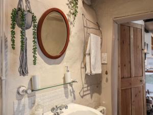 a bathroom with a sink and a mirror on the wall at Corner House in Saltburn-by-the-Sea +25 photos