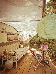 a room with a bed and a table and a chair at Le Mas des Pins in Beynes