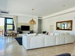 a living room with a white couch and a tv at Grimaud villa in Grimaud