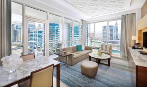 a living room with a view of a city at DoubleTree by Hilton Dubai Jumeirah Beach in Dubai