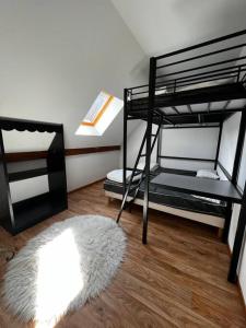 a room with two bunk beds and a rug at Charmant logement dans résidence in Super Besse
