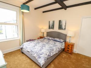 a bedroom with a bed and two windows at Station Avenue in Sandown