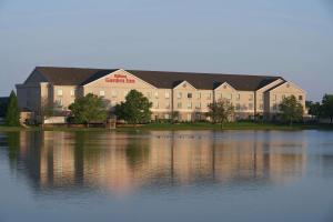 a large building with ducks in front of a lake at Hilton Garden Inn Evansville in Evansville