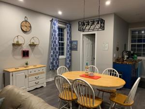 a kitchen and dining room with a table and chairs at Q Estate Pool cottage in Westport
