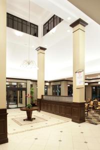 a lobby of a building with a potted plant at Hilton Garden Inn Sioux Falls South in Sioux Falls
