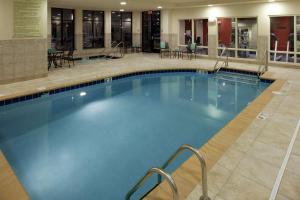 a large swimming pool in a hotel lobby at Hilton Garden Inn Sioux Falls South in Sioux Falls