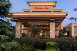 a building with a sign on top of it at Hampton Inn by Hilton Fort Smith in Fort Smith