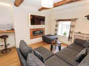 a living room with a couch and a fireplace at Tawny Owl in Carnforth