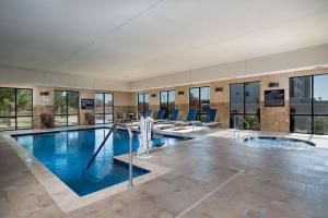 a large swimming pool with blue water in a building at Hampton Inn & Suites Fort Worth-Fossil Creek in Fort Worth