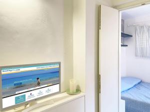 a tv sitting on a shelf in a bedroom at Casa Costanzo in Marciana Marina