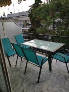 a table and chairs sitting on a patio at Athena Apartment in Néa Péramos