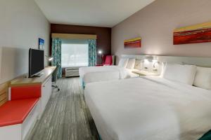 a hotel room with two beds and a flat screen tv at Hilton Garden Inn Fort Worth/Fossil Creek in Fort Worth