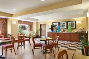 a restaurant with tables and chairs and a counter at Hampton Inn Gillette in Gillette