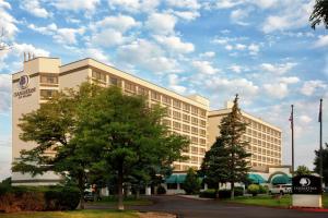 a building with a tree in front of it at DoubleTree by Hilton Grand Junction in Grand Junction