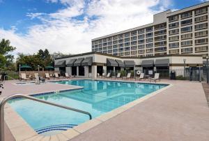 a hotel with a swimming pool in front of a building at DoubleTree by Hilton Grand Junction in Grand Junction