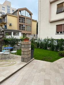 a patio with a table and chairs in front of a building at ROSE Downtown in Podgorica