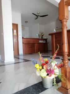 a lobby with a vase of flowers on the floor at Ta Adelfia in Pylos