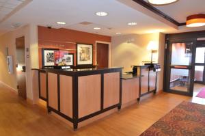 a lobby with a bar in the middle of a room at Hampton Inn Groton/Mystic in Groton