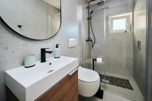 a bathroom with a sink and a toilet and a mirror at Apartmani Erik Umag in Umag +12 photos