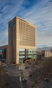 a large hotel building with a parking lot in front of it at DoubleTree by Hilton Qinghai - Golmud in Golmud