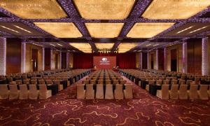 a large room with chairs and a screen in it at DoubleTree by Hilton Qinghai - Golmud in Golmud