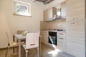 a kitchen with a small table and a stove at Dimora La Fiumara in Marina di Grosseto