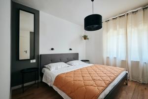 a bedroom with a large bed and a mirror at Apartmani Erik Umag in Umag
