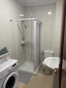 a bathroom with a shower and a toilet and a sink at Piso MORRIÑA en Camariñas centro in Camariñas +3 photos