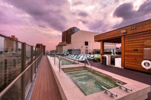 a balcony with a swimming pool on top of a building at Hilton Grand Vacations Club Hokulani Waikiki Honolulu in Honolulu