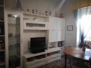 a living room with a tv in a white cabinet at casa di carlo in Alghero