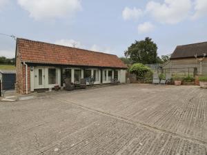 an empty parking lot in front of a building at Walnut Cottage in Ross on Wye