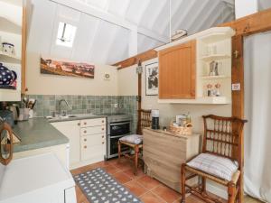 a kitchen with a sink and a stove top oven at Walnut Cottage in Ross on Wye