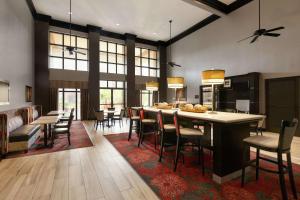 a kitchen and dining room with a table and chairs at Hampton Inn and Suites Houston Clear Lake NASA in Webster