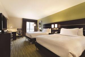 a hotel room with two beds and a television at Hilton Garden Inn Houston Northwest in Houston +39 photos