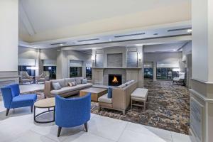 a lobby with couches and a fireplace at Hilton Garden Inn Houston/Sugar Land in Sugar Land