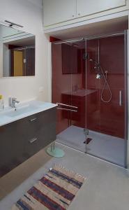 a bathroom with a glass shower and a sink at Ti Racconto di un Sogno Rooms - Cielo & Terra in Chianciano Terme