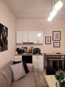 a living room with a couch and a kitchen at Cherry's apartment in Alonnisos