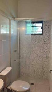 a bathroom with a toilet and a glass shower at Casa de verano en San Bernardino in San Bernardino