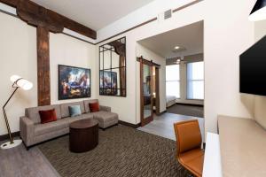 a living room with a couch and a tv at Homewood Suites by Hilton Indianapolis Downtown in Indianapolis