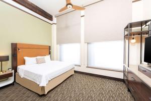 a bedroom with a bed and a flat screen tv at Homewood Suites by Hilton Indianapolis Downtown in Indianapolis +30 photos