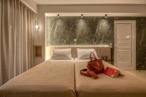 - une chambre dotée d'un grand lit avec deux sacs dans l'établissement Castro Beach Hotel, à Maleme